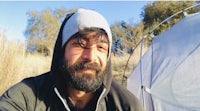 a bearded man with a beard in front of a tent
